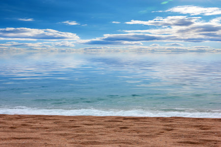 beautiful sandy beach and sunny sky as a place for active recreationの写真素材