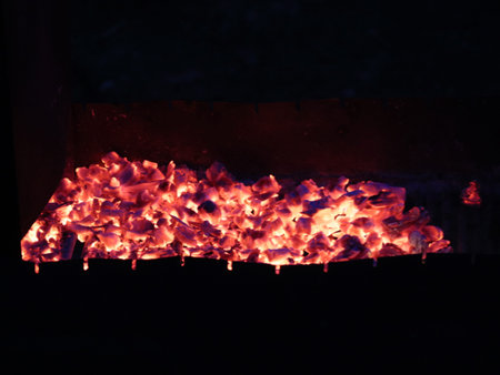 glowing coals in a brazier at nightの写真素材