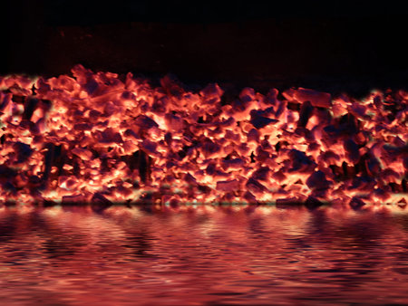 the red-hot coal fire is reflected in the water surface