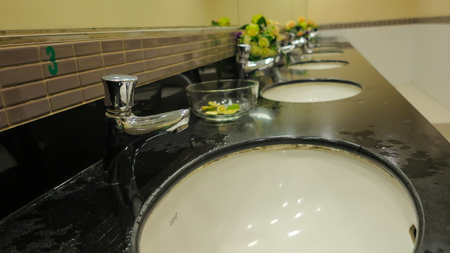 sinks and taps in a public toilet.の写真素材
