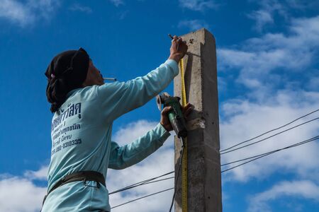 Petchabun,Thailand-July 8,2016:A man is working building a home and measuring some post.