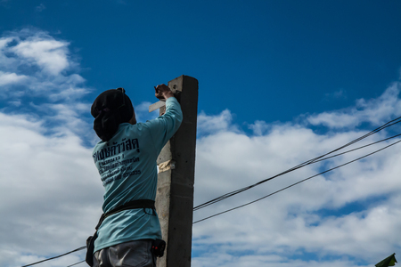 Petchabun,Thailand-July 8,2016:A man is working building a home and measuring some post.のeditorial素材