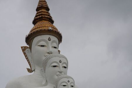 white Buddha statue with clouds.の写真素材
