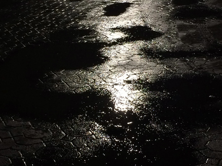 wet street pavement with reflection of traffic.の写真素材