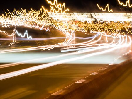 Blur tail traffic lights on road.