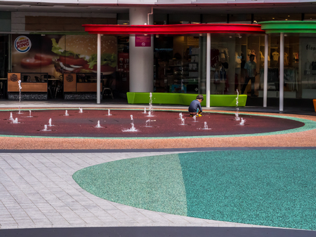 Children playing with water in park fountainのeditorial素材