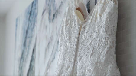 Wedding dress hanging on the hanger in the room.の写真素材
