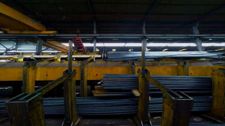 A vertical shot of a conveyor belt in a warehouse with metal barsの写真素材