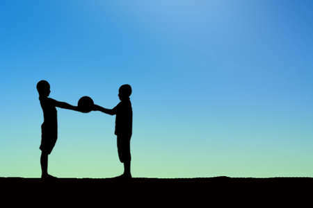 Silhouette of children playing soccer background sunset.の写真素材