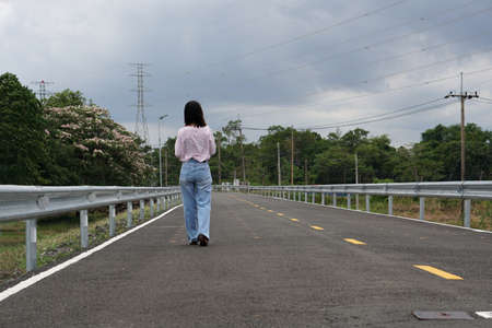 Women wearing pink shirts walking on the streets.       の写真素材