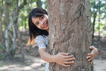 Asian women huging trees , the concept of love for the worldの写真素材