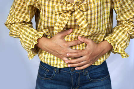 Woman suffer from stomachache.Chronic gastritis. Abdomen bloating concept.