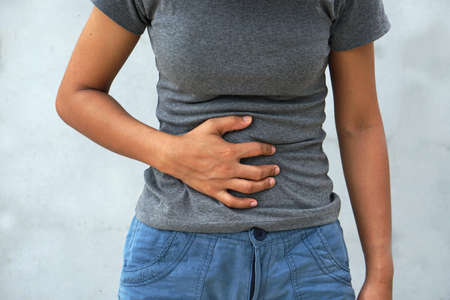 Woman has stomachache,menstrual period cramp, abdominal pain, food poisoningの写真素材