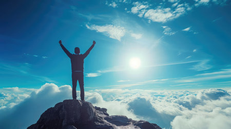 Silhouette of businessman celebrating raising arms on the top of mountain with over blue sky and sunlight.concept of leadership successful achievement with goal,growth,up,win and objectiveの素材