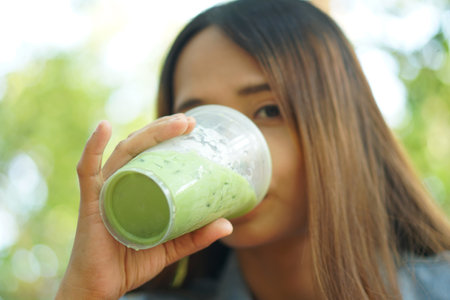 woman drinking iced green tea