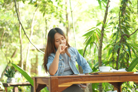 Woman is tired of working in a coffee cafeの写真素材