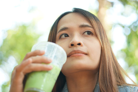 woman drinking iced green teaの写真素材