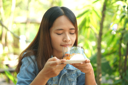 Woman eating cake in coffee cafeの写真素材