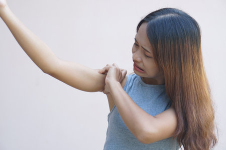 Asian woman having shoulder painの写真素材