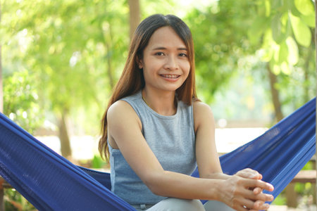 Woman sitting in a hammock in a coffee shop