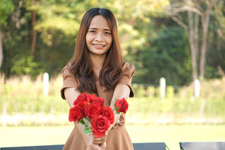 Asian woman smiling happily green grass backgroundの写真素材