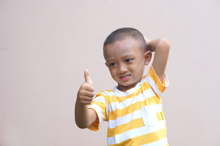 Asian boy doing his hand as a great sign