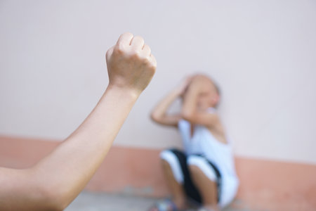 Boys raise their hands to prevent violence against children.の写真素材
