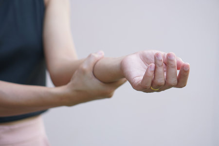 Asian women have muscle weakness and numbness in their arms.の写真素材