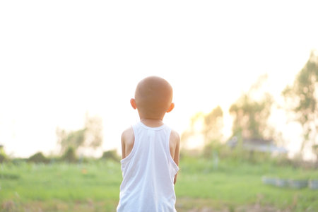 a boy watching the sunset happilyの写真素材