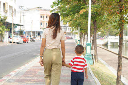 Mother takes baby for a walk in the park holidayの写真素材