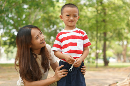 Mother and baby playing in the park happily.の写真素材