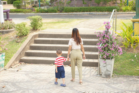 Mother takes baby for a walk in the park holiday