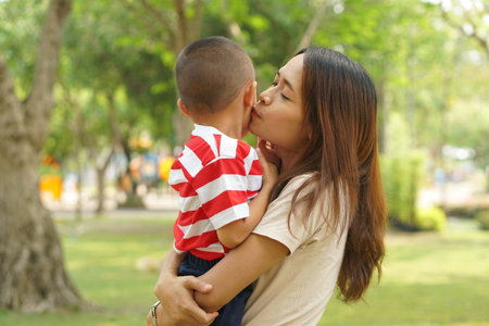 Mother and baby playing in the park happily.