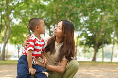 Mother and baby playing in the park happily.の写真素材