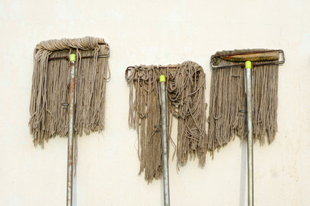 Mop next to the wall of the house