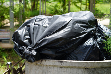 black bag overflowed from the garbage collector.の写真素材