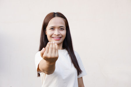 woman waved her hand, calling for him to come in.の写真素材