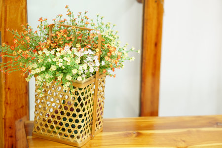 flowers in the basket are placed on the table in the coffee shop.の写真素材