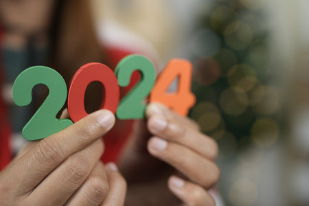 Happy New Year 2024 concept, woman holding 2024 numbers