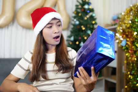 Merry Christmas 2024 concept Asian women are happy and delighted to receive Christmas gifts.の写真素材