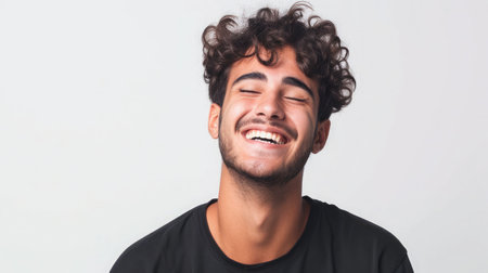 Young Brazilian man isolated on white background laughingの素材