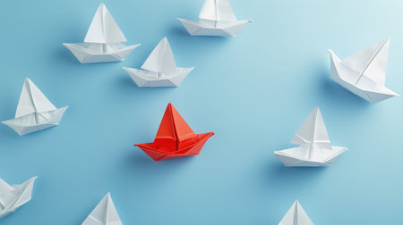 Group of white paper ship in one direction and one red paper ship pointing in different way on blue background. Business for innovative solution concept.の素材