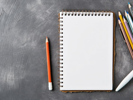 Blank notepad on gray desktop. Education, text, copy space concept --ar 4:3 --v 6 Job ID: e147ad70-a6e3-485f-8222-7e8689e99b5aの素材