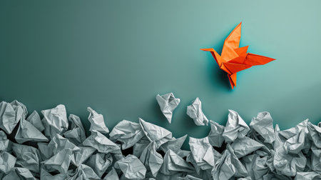 Concept of new idea and creative thinking as a symbol of innovation and inspiration metaphor as a group of crumpled papers with one different paper transforming into an origami bird in flight.の素材