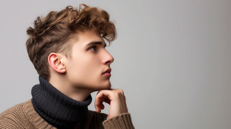 Side view portrait of thinking stylish young man looking awayの素材