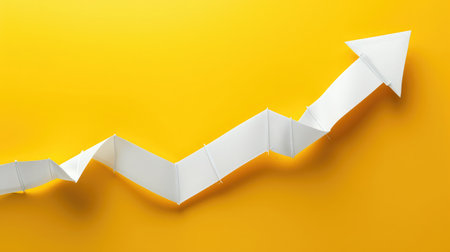Right-up arrow cutted from solid sheet of yellow paper and curved up of one side with white paper underlay showing growth of stock market or up directionの素材