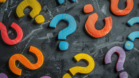Colorful question marks on chalkboard background. Close up.の素材
