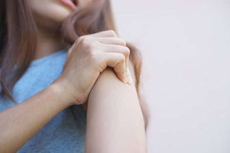 Asian woman having shoulder pain