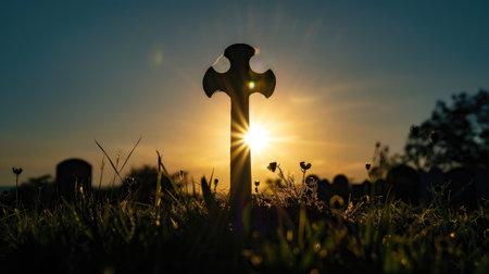 Silhouette of a cross with bright sunの素材