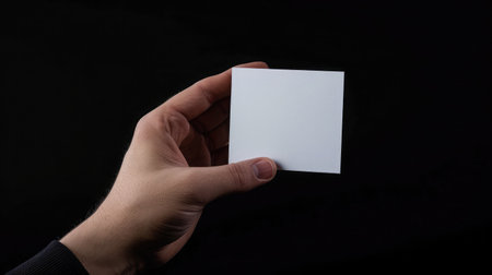 Hand holding ballot paper for election vote concept at black background.の素材